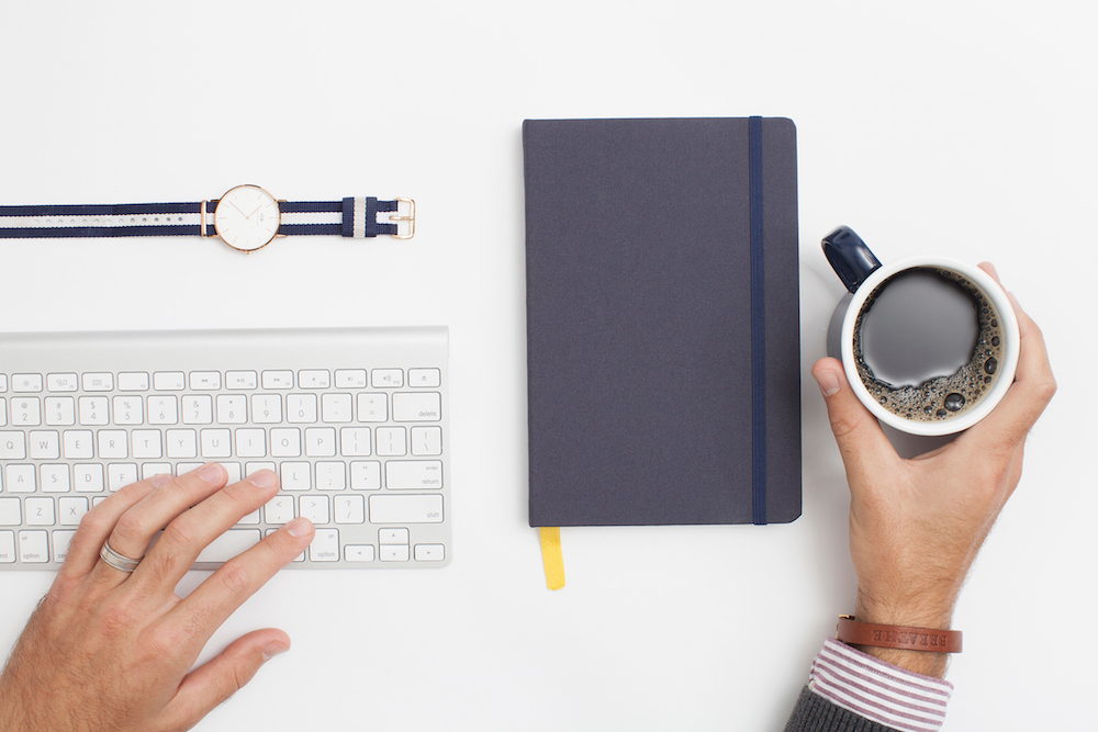 A set of objects around a modern desk.